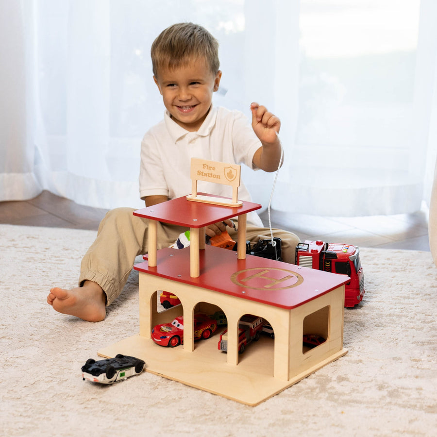Wooden toy fire station with three arched ground floor garages